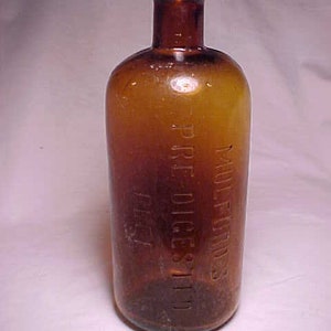 May include: A brown glass bottle with a clear glass stopper. The bottle is labeled "Mulford's Pare Diges-Tiv 1/2 fl oz".