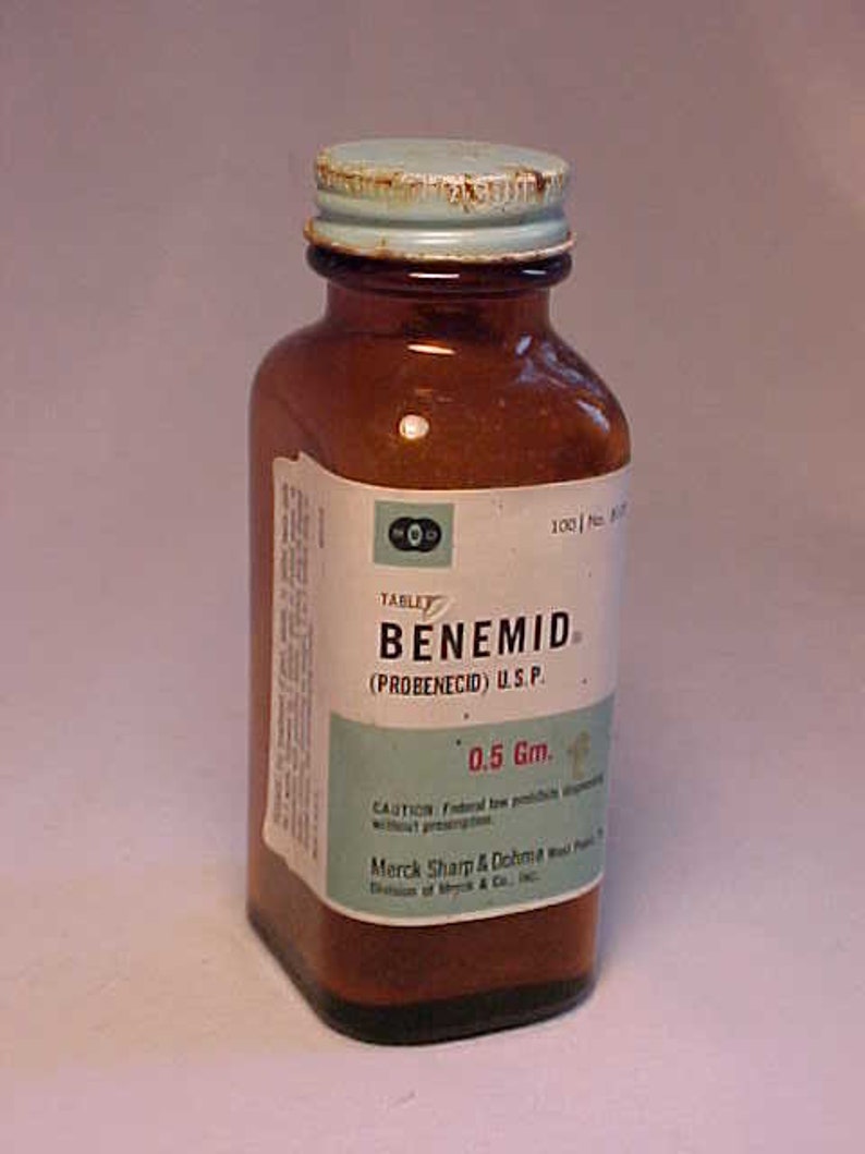 May include: A brown glass bottle with a blue lid labeled "TABLET BENEMID (PROBENECID) U.S.P. 0.5 Gm.". The label also includes the text "CAUTION: Federal law prohibits dispensing without prescription. Merck Sharp & Dohme, West Point, Pa. Division of Merck & Co., Inc."