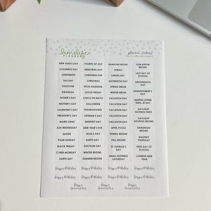 May include: A set of planner stickers with a white background and black text. The stickers feature a variety of holidays and special dates, including New Year's Day, Columbus Day, Juneteenth, Tax Day, Passover, Kwanzaa, Father's Day, Mother's Day, Valentine's Day, President's Day, Mardi Gras, Ash Wednesday, Easter, Palm Sunday, Black Friday, Cyber Monday, Earth Day, Fourth of July, Memorial Day, Christmas Eve, Christmas, Rosh Hashanah, Good Friday, Spring Break, Winter Break, Cinco de Mayo, Halloween, Thanksgiving, Veteran's Day, Sweetest Day, New Year's Eve, Boss's Day, Earth Day, Election Day, Winter Begins, Summer Begins, Ramadan Begins, Diwali, Labor Day, Ascension Day, Yom Kippur Begins, Last Day of School, Groundhog Day, Grandparent's Day, Martin Luther King Jr Day, Daylight Savings Ends, Daylight Savings Begins, Hanukkah Begins, Maundy Thursday, First Day of School, Chinese New Year. The stickers also include the text "Happy Birthday" and "Happy Anniversary".
