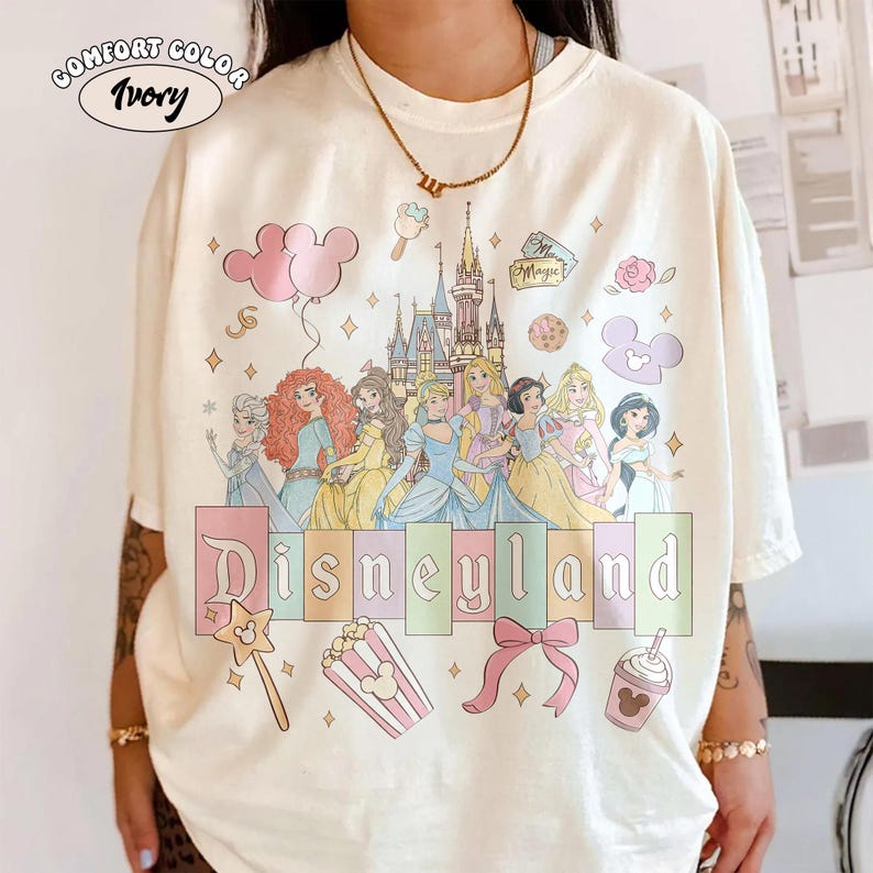 May include: A white ceramic mug with a black handle and the text "But First, Coffee" in a black, handwritten-style font. The mug is on a white surface.