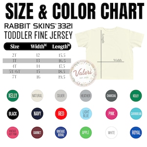 May include: A cream-colored toddler fine jersey t-shirt with a size and color chart. The chart lists sizes 2T to 7T, with width and length measurements in inches. Color options include Kelly, Black, Navy, Red, and more. The brand is Rabbit Skins.