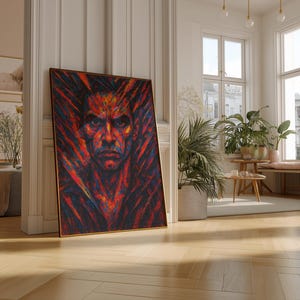 May include: A framed portrait with a striking, colorful depiction of a man's face. The artwork features a vibrant palette of red, orange, and blue hues, creating a dramatic and intense visual effect. The painting is leaning against a white wall in a well-lit room.