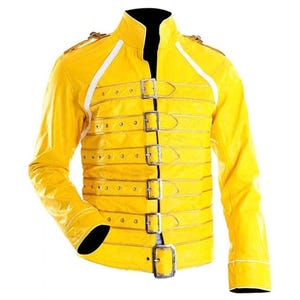 Könnte beinhalten: Eine leuchtend gelbe Jacke mit Stehkragen und langen Ärmeln. Die Jacke hat mehrere silberne Schnallen und weiße Streifen an Schultern und Ärmeln. Die Manschetten und der Kragen sind schwarz.