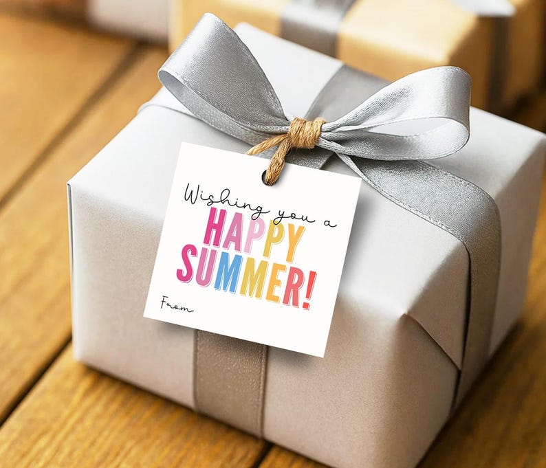 May include: A square white gift tag featuring the black text Wishing you a and the colourful text HAPPY SUMMER! in pink, yellow, blue, and orange, followed by the word From. The tag is attached with twine to a silver gift box wrapped in a silver ribbon.