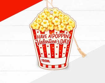 May include: A Valentine's Day gift tag shaped like a popcorn container. The tag is red and white striped with a popcorn graphic at the top. Text reads "Have a Poppin' Valentine's Day" and "From:" is printed on the bottom.