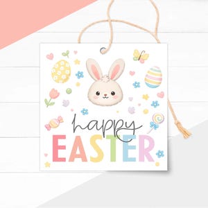 May include: Square Easter tag with a bunny face, colorful eggs, flowers, and the words "happy EASTER" in pastel colors. The tag is white with a string for hanging.