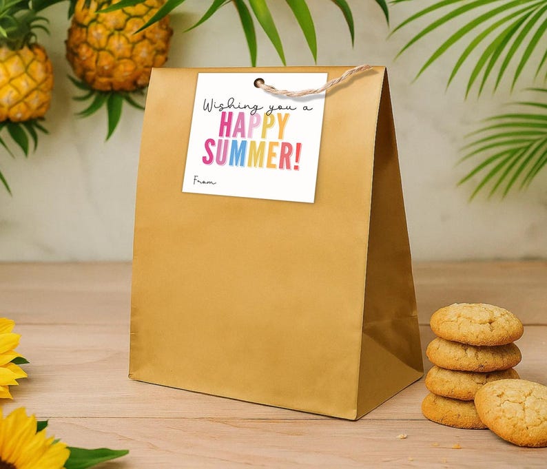 May include: A gold paper gift bag with a square white tag attached by a brown twine string. The tag features the black text "Wishing you a" and the colourful text "HAPPY SUMMER!" with the word "From" printed in black at the bottom left corner.