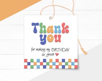 May include: A white square gift tag with the words "Thank you" in colourful bubble letters. Below, it reads "for making my BIRTHDAY so great" with a small red heart. The bottom border has a repeating pattern of colourful squares, and a twine string is attached.