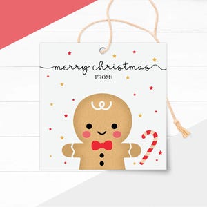 May include: A square Christmas gift tag featuring a gingerbread man illustration. The tag has the words "merry christmas" and "from" in black script. The gingerbread man has a red bow tie and a candy cane.