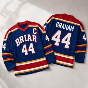 May include: Two blue hockey jerseys with red and white accents. One jersey has "BRIAR" and the number "44" in white. The other jersey has "GRAHAM" and the number "44" in white. Both jerseys have the number "4" on the sleeves.