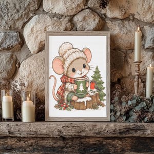 May include: A framed illustration of a cartoon mouse wearing a cream-colored knit hat and a red plaid scarf, sitting on a snowy tree stump. The mouse holds a green mug with a white tree design, accompanied by a small robin and a pine tree.