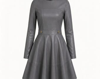 May include: A long-sleeved gray dress featuring a round neckline, a fitted bodice with vertical seam detailing, and a defined waistline accented by two small gold-toned buttons. The skirt is flared with a horizontal seam above the hemline.