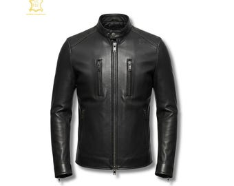 May include: A black leather jacket featuring a stand-up collar with a snap button closure, a central full-length zipper, and two vertical zippered chest pockets. The jacket has long sleeves with zippered cuffs and a smooth, matte finish.