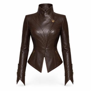 May include: A dark brown leather jacket featuring a high standing collar, an asymmetrical front closure secured with a single metallic button, curved seam detailing across the chest, two zippered waist pockets, and pointed cuffs with buttons.