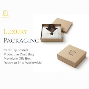 May include: A brown leather garment folded inside a square tan cardboard gift box, wrapped in white tissue paper with a dark circular seal. A separate tan lid sits nearby, and a closed tan box features a dark logo of a leather hide shape.