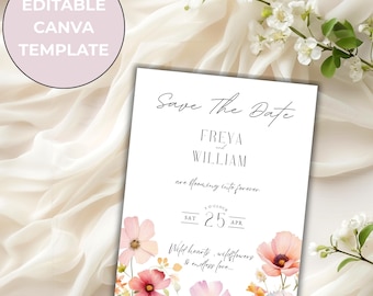 May include: A white wedding invitation with floral watercolor illustrations. The text reads "Save The Date" with the names Freya and William, and the date April 25th. The invitation is surrounded by flowers and greenery.