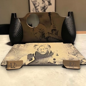Puede incluir: Un conjunto de carcasa para mando personalizado con una placa frontal color canela que presenta un retrato grabado con láser de un personaje de pelo puntiagudo sosteniendo una espada, agarres laterales negros texturizados y dos gatillos con L2 y R2.