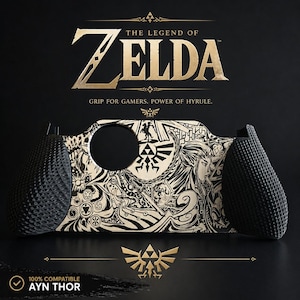 May include: A black and cream-colored gaming grip for the Ayn Thor, featuring intricate line art of characters and symbols from The Legend of Zelda. The grip has textured black side handles and a central panel with a circular cutout and gold text.