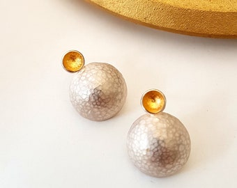 Hammered domed ear studs in silver with small fine gold bowl