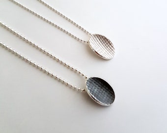 Pendant made in sterling silver with textured surface