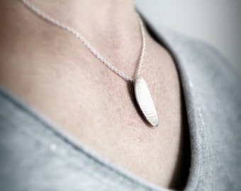 Pendant necklace  silver slightly domed with textured surface