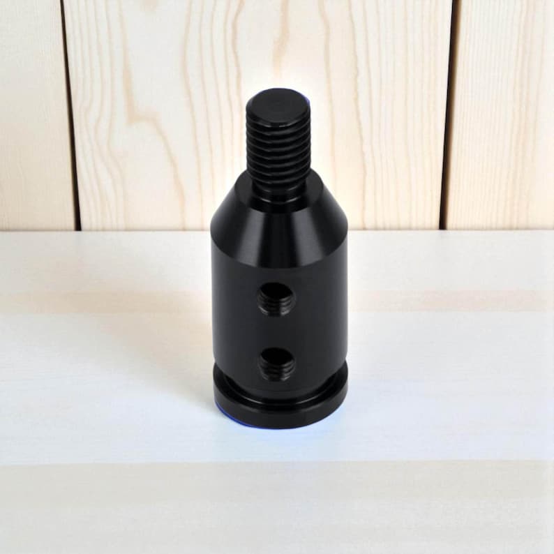 Black aluminum shift knob adapter for automatic transmission or push-down-to-shift systems like BMW. Features threaded holes for secure installation on non-threaded shifters. Ideal for JDM cars, custom gear knobs, and sim racing setups requiring universal compatibility.