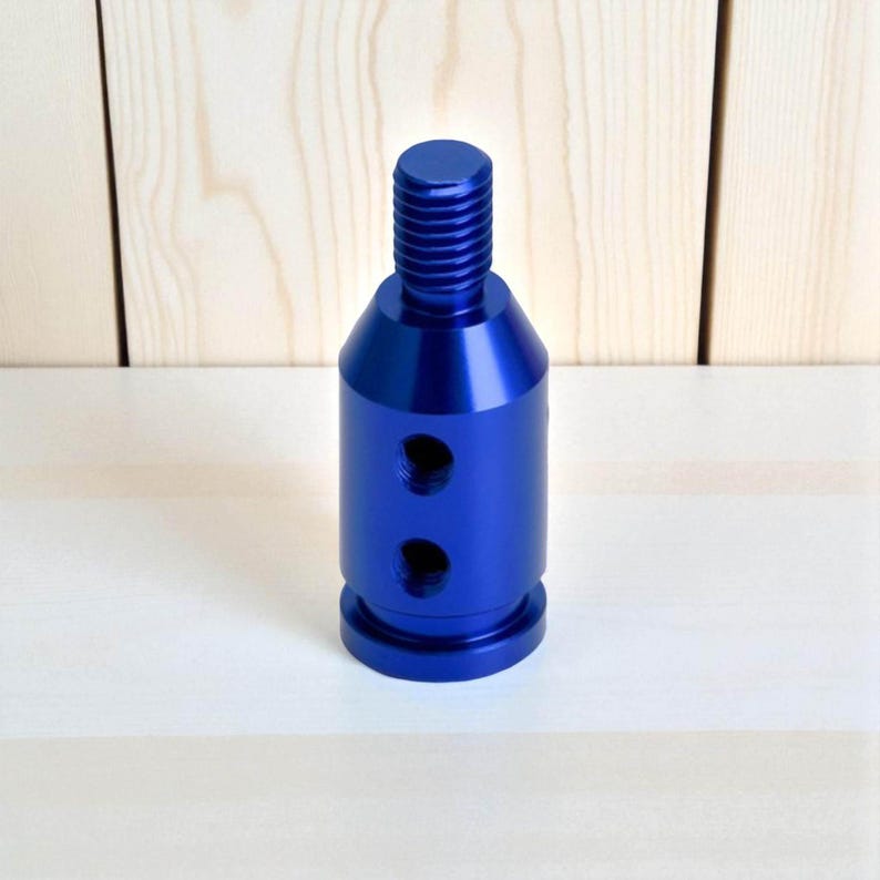 Blue anodized aluminum gear shift adapter designed for automatic or push-down-to-shift transmissions. This universal converter fits non-threaded levers and allows easy installation of custom shift knobs. Perfect for drift builds, JDM interiors, and performance vehicles.