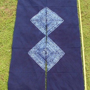 May include: A pair of indigo blue curtains with a white diamond pattern. The curtains are made of a soft, woven fabric and have a simple, elegant design.