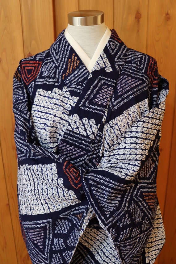 Traditional indigo blue kimono with intricate patterns representing tranquility and wisdom in Japanese culture