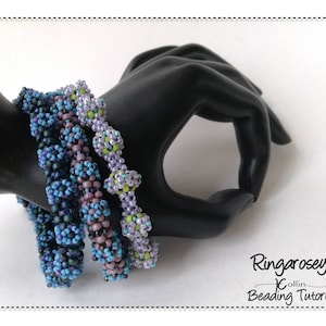 May include: Four beaded bracelets in shades of purple, blue and green. The bracelets are stacked on a black mannequin hand. The text "Ringarosey Collin Beading Tutorial" is visible in the bottom right corner of the image.