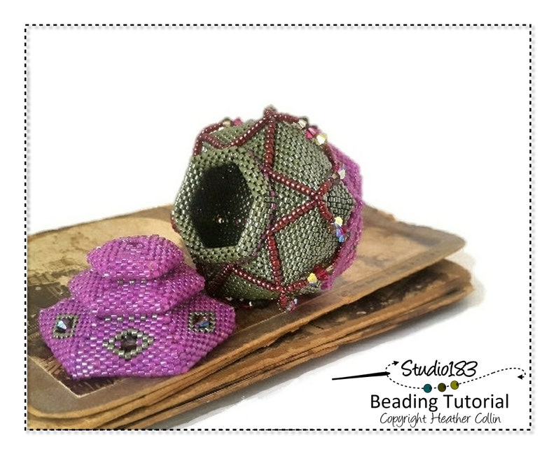 May include: A close-up of a beaded sphere with a geometric design in shades of green, red, and purple. The sphere is open and reveals a black interior. A smaller, purple beaded sphere sits on a stack of old books. The image includes the text "Studio183 Beading Tutorial Copyright Heather Collin".