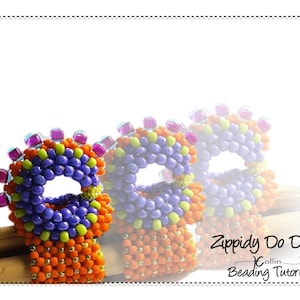 May include: Three beaded rings in shades of purple, orange, yellow, and green. The rings are stacked on top of each other and have a hole in the center. The rings are made with small beads and have a textured surface. The text "Zippidy Do Da Collin Beading Tutorial" is visible in the bottom right corner of the image.