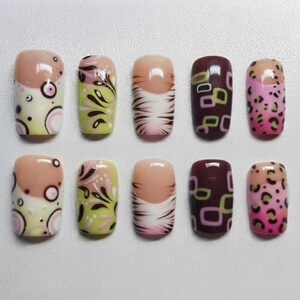 May include: A set of ten press-on nails featuring diverse designs including cream with pink circles, light green with black swirls, white with brown tiger stripes, dark brown with lime green squares, and pink with black leopard spots.