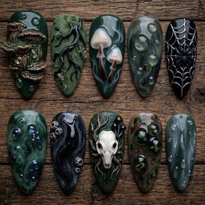 May include: A set of ten almond-shaped press-on nails featuring dark, nature-inspired 3D designs. Elements include sculpted mushrooms, mossy branches, a spider web with a spider, a white animal skull, a black slug, and raised water droplets.
