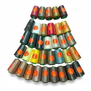 May include: A selection of thread spools in a pyramid arrangement. The spools are in shades of red, green, yellow, brown, and grey. Each spool has a green base and a gold label with a circular design.