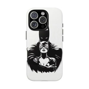 May include: A white phone case featuring a black and white illustration of Batman and Catwoman. The design shows Batman standing behind Catwoman, with both characters in a stylized, comic book art style.