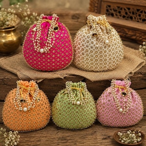 May include: Five drawstring pouches in bright pink, cream, orange, light green, and soft pink. Each pouch features a repeating gold embroidered pattern, a beaded handle with small metallic bells, and a gathered top closure with gold drawstrings.