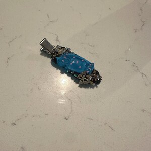 blue hairclip decorated with charms