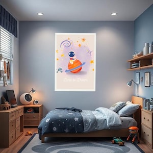 May include: A framed print featuring an astronaut on a planet with the text "Dare to Dream." The artwork has a soft color palette with stars and swirls. The print is displayed in a child's bedroom, above a bed with blue and gray bedding.