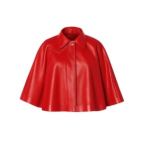 May include: A vibrant red cape with a classic collar and button closure. The cape features a sleek, smooth texture and a tailored design, offering a stylish outerwear option. The garment is designed with a wide, flowing silhouette.