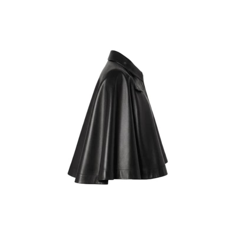 May include: A black leather cape with a collar and a flared silhouette. The cape has a smooth, shiny finish and appears to be made of a high-quality material. The design includes a small pocket on the front.