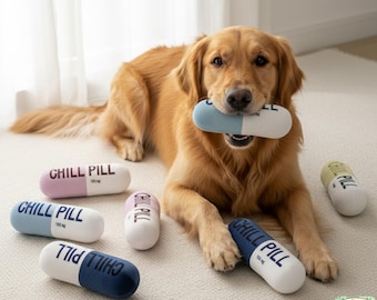 May include: A golden retriever dog is lying on a light-colored rug, holding a blue and white pill-shaped dog toy in its mouth. Several other colorful "Chill Pill" dog toys are scattered around, each with the text "Chill Pill" and "100 mg".
