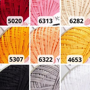 May include: Nine skeins of colourful yarn in various shades, including red, pink, cream, yellow, orange, black, grey, and white. Each skein is labelled with a number. Suitable for knitting and crochet projects.