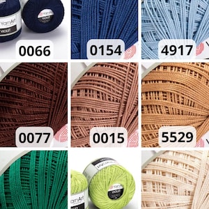 May include: A selection of YarnArt Violet yarn skeins in diverse colours. The image shows skeins in navy blue, light blue, brown, green, and beige. Each skein is labelled with a colour code, including 0066, 0154, 4917, 0077, 0015, 5529, 6334, 5352, and 6194.