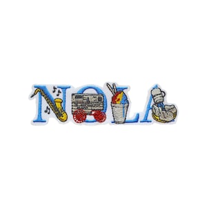 May include: Embroidered patch with the word "NOLA" in blue with various icons representing New Orleans culture. The icons include a saxophone, a streetcar, a snow cone, and a beignet.