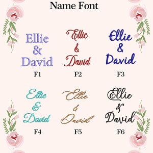 May include: A display of name fonts for personalization. The text "Ellie & David" is shown in six different styles, each in a different color. The words are surrounded by a floral border with pink roses and green leaves. The text "Name Font" is at the top.