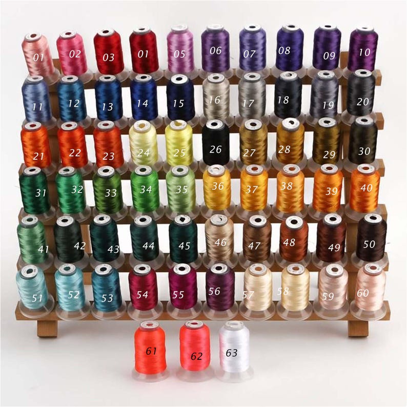 May include: A wooden display rack filled with 63 spools of colorful embroidery thread. The spools are arranged in rows, showcasing a wide range of colors, from pinks and reds to blues, greens, and browns. Each spool is labeled with a number.