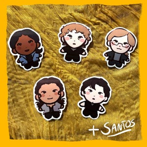 May include: A collection of five cartoon character stickers with a +Santos signature on a gold fabric background. Each sticker features a different character with unique hairstyles and outfits, including glasses and various jackets.