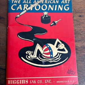 May include: Vintage "All American" art cartooning book cover. The cover features a red background with a cartoon illustration of a person floating in black ink. The text "THE 'ALL AMERICAN' ART CARTOONING" is displayed in blue and white.