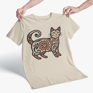 May include: A white ceramic mug with a black handle and the text "But First, Coffee" in a handwritten style. The mug is on a white surface. The mug is approximately 4 inches tall.